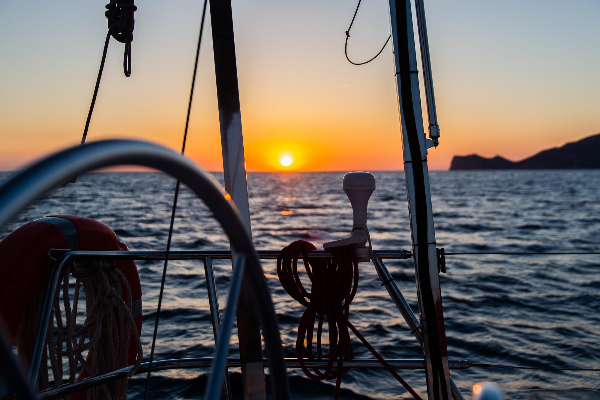 Sailing Yacht at Sea in Mallorca Sailing yacht cruising the coast of Mallorca at sunset during private charter